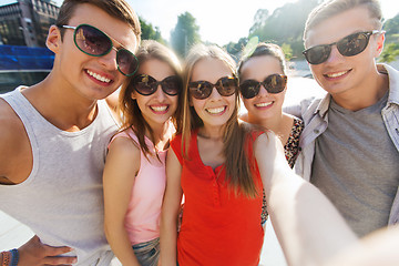 Image showing smiling friends taking selfie