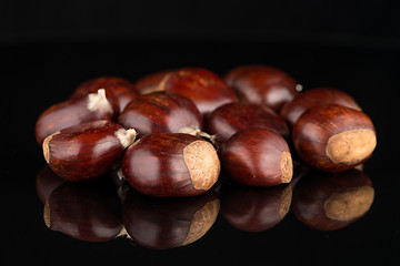 Image showing Chestnuts on a black reflective background