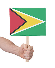 Image showing Hand holding small card - Flag of Guyana