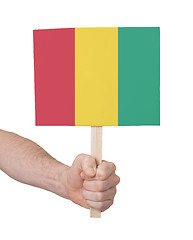 Image showing Hand holding small card - Flag of Guinea