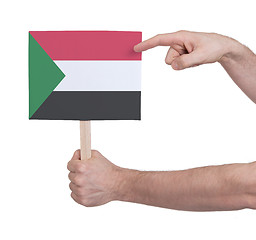 Image showing Hand holding small card - Flag of Sudan