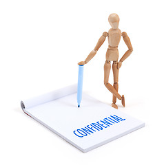 Image showing Wooden mannequin writing - Confidential