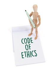 Image showing Wooden mannequin writing - Code of ethics