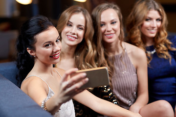 Image showing women with smartphone taking selfie at night club