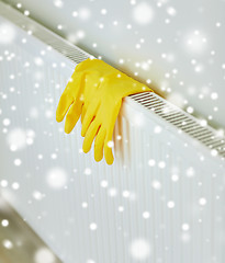 Image showing close up of rubber gloves hanging on heater