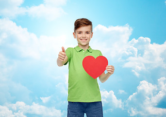 Image showing happy boy showing red heart shape and thumbs up