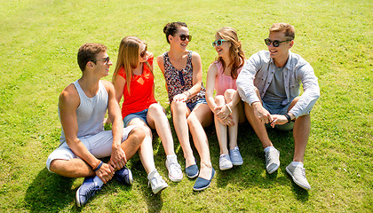 Image showing group of smiling friends outdoors sitting in park