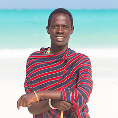 Image showing Traditonaly dressed black man on beach. 