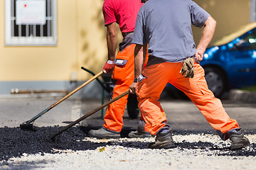 Image showing Asphalt surfacing manual labor.