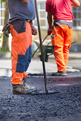 Image showing Asphalt surfacing manual labor.