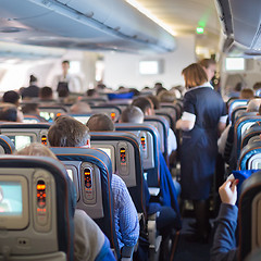 Image showing Stewardessand passengers on commercial airplane.