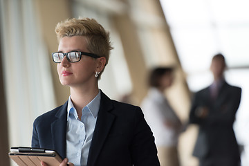 Image showing business woman  at office with tablet  in front  as team leader