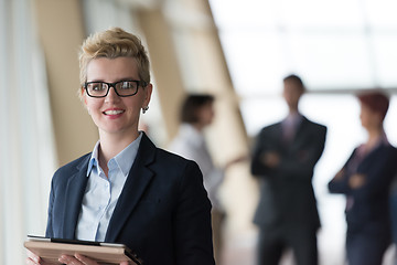 Image showing business woman  at office with tablet  in front  as team leader