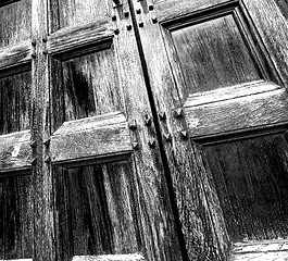 Image showing abstract texture of a brown antique wooden old door in italy   e