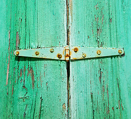 Image showing in the old wall a hinged window green wood and rusty metal