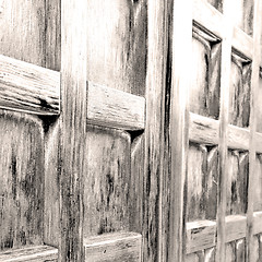 Image showing home texture of a brown antique wooden old door in italy   europ