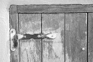 Image showing in the old wall a hinged window blue wood and rusty metal