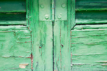 Image showing in the old wall a hinged window green wood  