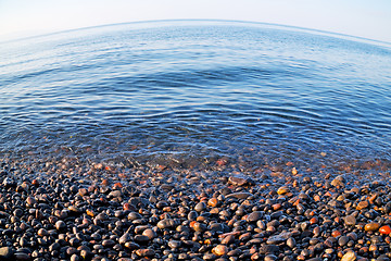 Image showing stone in the coastline sunrise and light ocean white sky