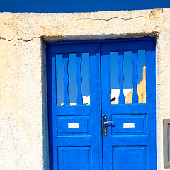 Image showing blue door in antique village santorini greece europe and white w