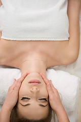 Image showing woman getting face and head  massage in spa salon