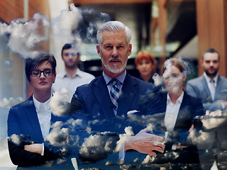 Image showing double exposure of senior business man with his team at office