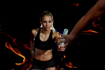 Image showing double exposure athletic runners passing baton in relay race