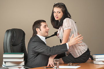 Image showing Businesswoman is seducing her boss at office