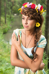 Image showing Young beautiful woman in wreath of flowers