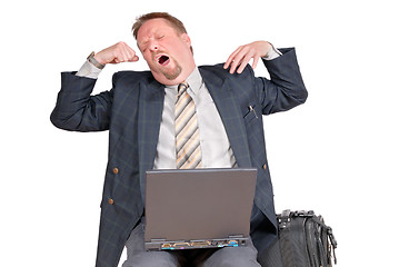 Image showing Yawning traveling businessman