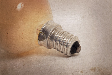 Image showing Old orange lightbulb isolated on a white background