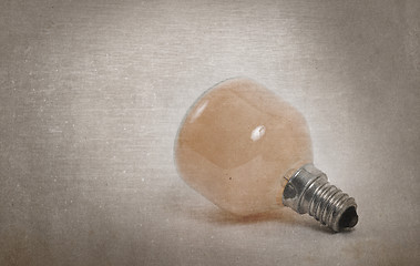 Image showing Old orange lightbulb isolated on a white background