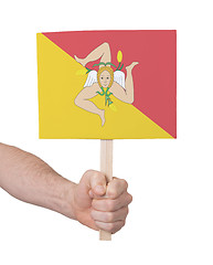 Image showing Hand holding small card - Flag of Sicily