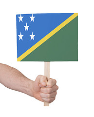 Image showing Hand holding small card - Flag of Solomon Islands