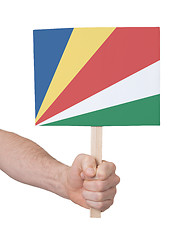 Image showing Hand holding small card - Flag of Seychelles