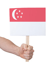 Image showing Hand holding small card - Flag of Singapore