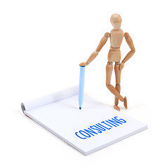 Image showing Wooden mannequin writing - Consulting