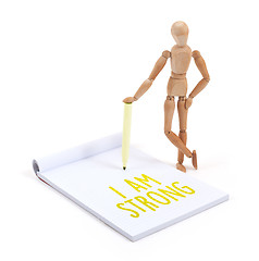 Image showing Wooden mannequin writing - I am strong