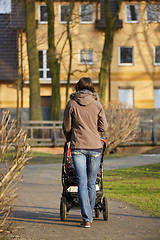 Image showing woman with pram in autumnal park