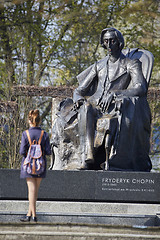 Image showing Young woman standing near Chopin statue