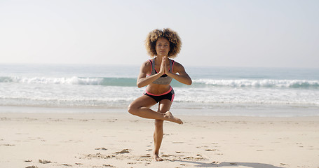 Image showing Woman Is Doing Yoga On The Beach