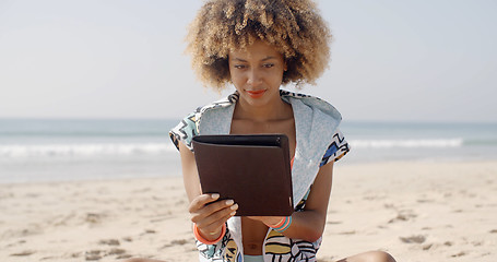 Image showing African American Girl Using Tablet Pc At Beach