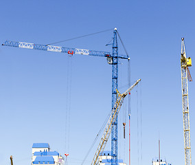 Image showing Industrial landscape with silhouettes of cranes on the sky backg