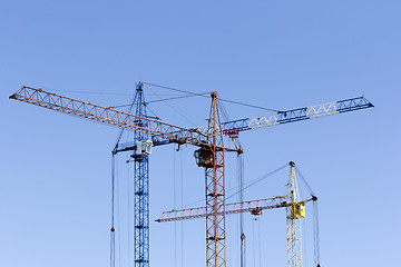 Image showing Industrial landscape with silhouettes of cranes on the sky backg