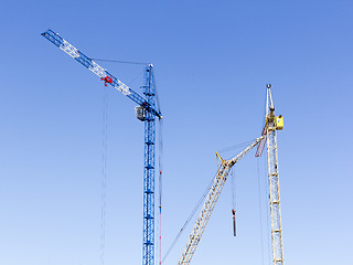 Image showing Industrial landscape with silhouettes of cranes on the sky backg