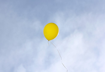 Image showing Yellow balloon flying on a blue sky background