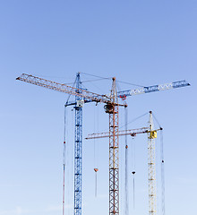 Image showing Industrial landscape with silhouettes of cranes on the sky backg