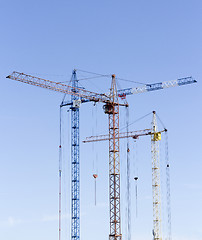Image showing Industrial landscape with silhouettes of cranes on the sky backg