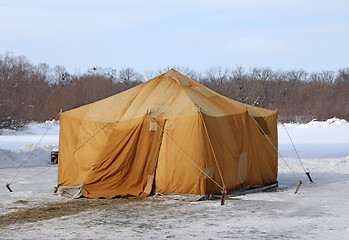 Image showing Military khaki tent in the snow polar region in a forest