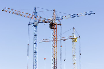 Image showing Industrial landscape with silhouettes of cranes on the sky backg